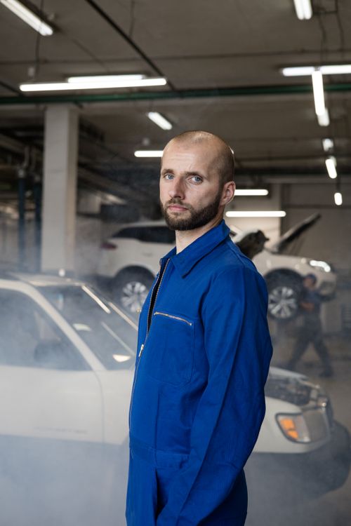 Mechanic standing near car